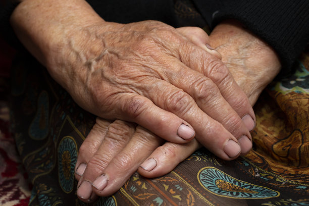 奶奶坐在那里，双手放在膝盖上图片下载