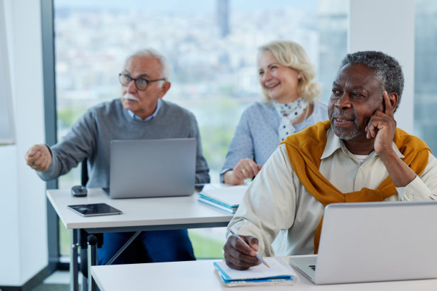 一位多元文化的大四学生和他的同学们在教室里听讲座。图片下载
