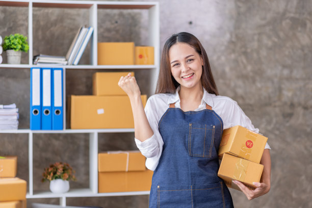 创业中小企业小企业企业家自由亚洲妇女使用笔记本电脑与盒子快乐的成功快乐的亚洲妇女，她的手举起在线营销包装和交付中小企业的想法概念图片下载