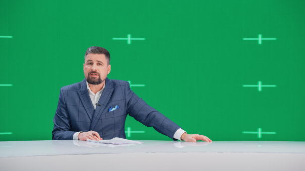 新闻演播室电视现场新闻节目:白人男性主持人报道，绿色屏幕色度关键屏幕画面。有线电视频道主播谈话，倾听。网络传播模型图片下载