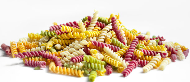 白色底色的彩色意大利面。用蔬菜和草药天然染料制成的儿童膏。面食background.Banner。图片下载