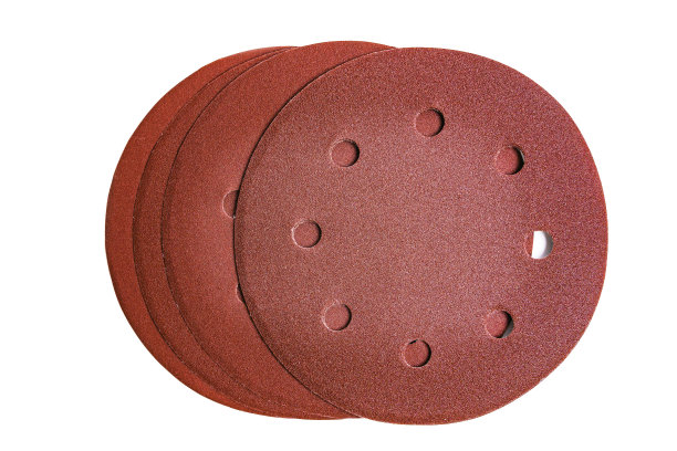 带有孔的圆形砂纸盘，用于研磨不同类型的砂粒，隔离在白色背景上。图片下载