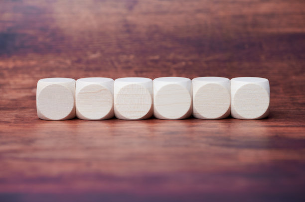 在木制背景上排成一行的六个木制立方体图片下载