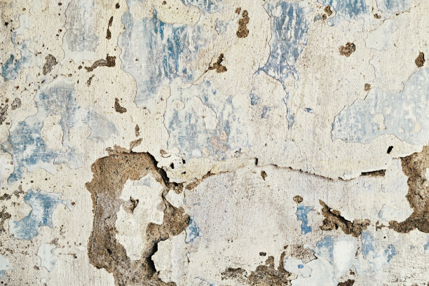 旧而肮脏的墙壁剥落油漆和裂缝纹理。垃圾摇滚内部背景特写图片下载