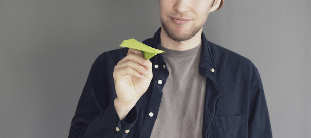 手里捧着一架纸飞机，标志着梦想之旅的开始图片下载