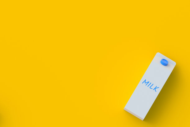 牛奶包装在角落的橙色背景。乳品饮料。健康的饮料。前视图。副本的空间。三维渲染图片下载