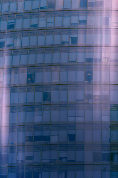 曲线玻璃建筑，深色钢窗系统，蓝色晴空背景，阳光明媚的现代办公大楼。图片下载