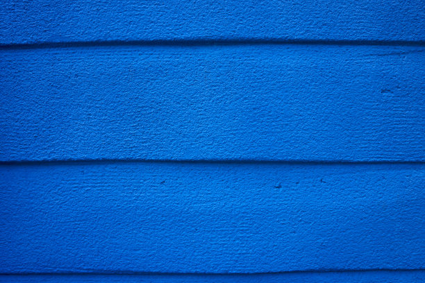 混凝土墙上的蓝色油漆。图片下载