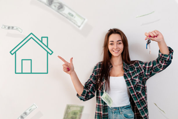 购买和租赁房地产。一个穿着格子衬衫的微笑女人拿着一串钥匙，指着一张绿色房子的照片。白底飞钱图片下载