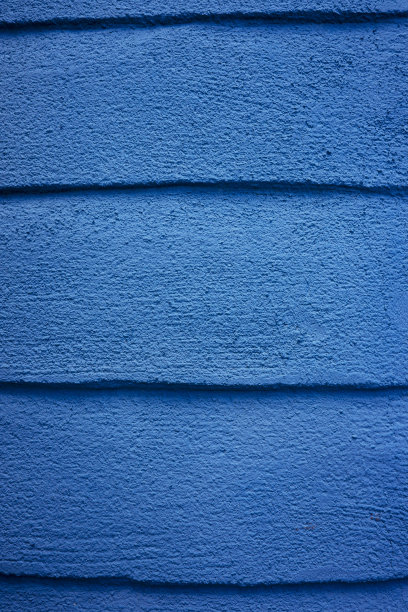 混凝土墙上的蓝色油漆。图片下载