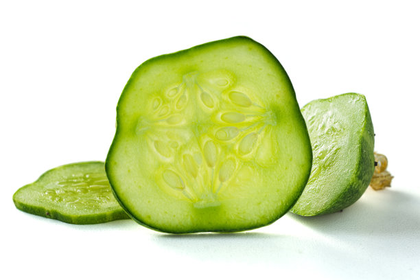 鲜绿黄瓜片微距照片。带籽的圆形黄瓜片。绿黄瓜果肉图片下载