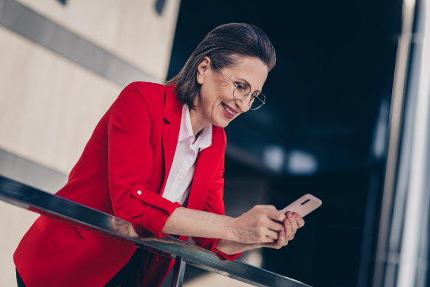 甜美迷人的高级律师女士穿着红色西装聊天现代小玩意户外城市小镇街道的照片图片下载
