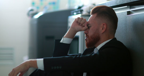 商人坐在家里的地板上感到沮丧和焦虑图片下载