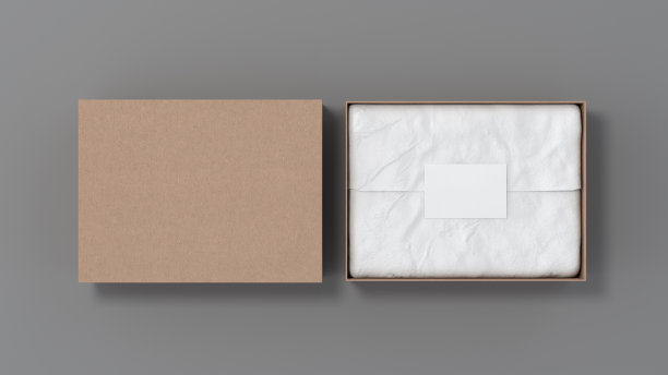 礼品盒模拟盖。有空白标签或在包装纸上印有名片的硬纸盒。灰色的背景。视图上方。图片下载