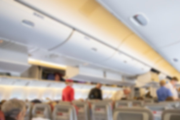 飞机内部、机舱、乘客座位模糊背景图片下载
