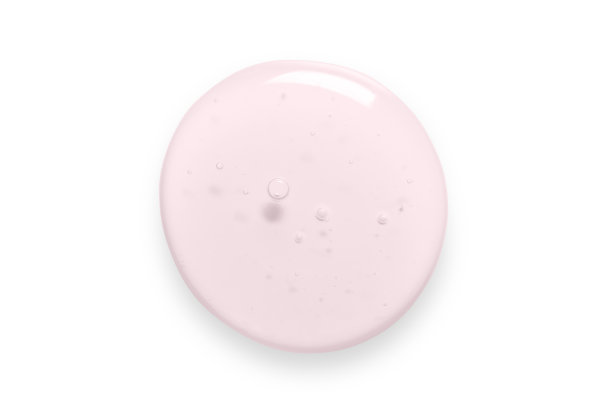 粉色凝胶滴特写。润肤霜用于面部或身体皮肤的化妆品孤立在白色背景上。图片下载