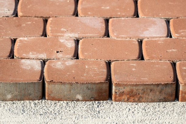 棕色混凝土渗透地板组装在砂石基板上。阳光下的砖块抽象照片图片下载