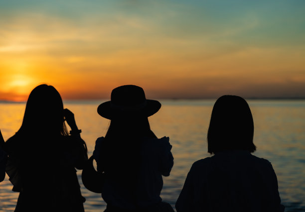 在海边看日出的男子正在用手机拍照图片下载