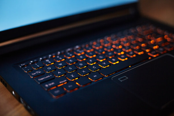 笔记本电脑键盘与橙色霓虹灯照明，背光键盘。图片下载