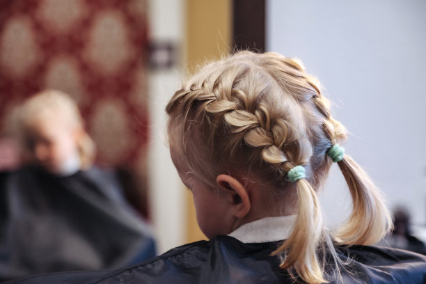 理发师为可爱的小女孩做时髦漂亮的发型图片下载