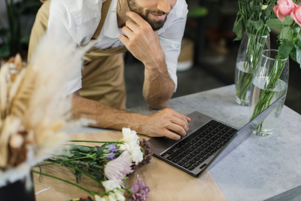 近观白人商人专业设计师，花匠装饰使用笔记本电脑图片下载