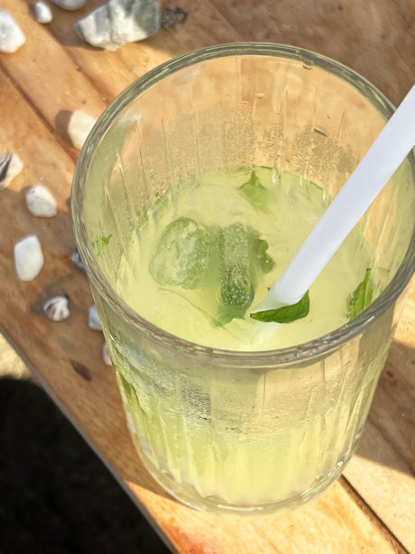 享受清凉的柠檬水与薄荷叶在海滩，宏观的看法。图片下载