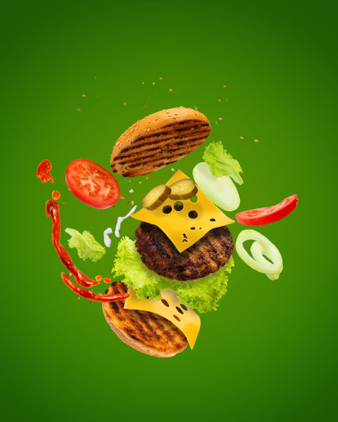大美味汉堡与飞行元素。飞汉堡。绿色背景。双层芝士汉堡图片下载