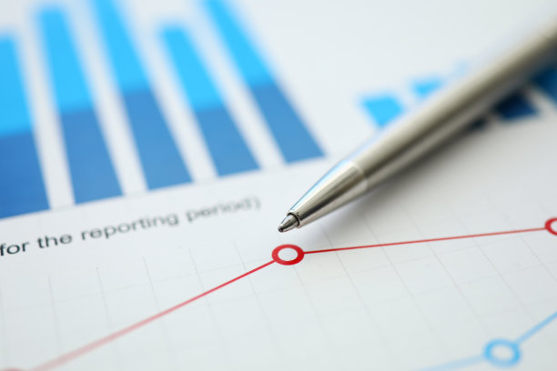 桌子上是用图表和笔写的财务报告图片下载