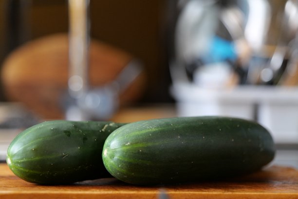 两根黄瓜放在木板上图片下载