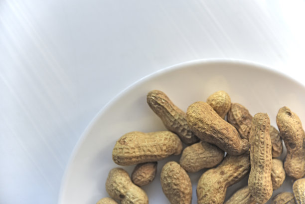 坚果白色盘子里有壳的花生图片下载