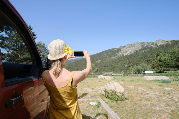 不明身份的女人在汽车附近拍山的照片图片下载