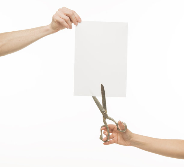 手拿剪刀靠近白纸图片下载