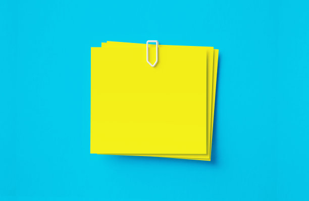 黄色的不干胶笔记坐在蓝色的背景图片下载