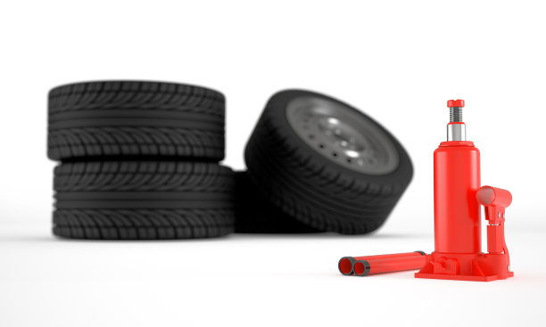 红色的液压千斤顶背景是一组汽车车轮图片下载