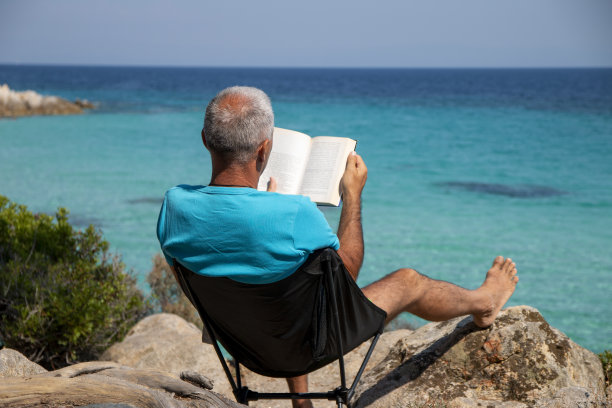 男人正在看旁边的一本书图片下载