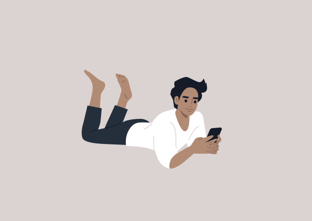 一个年轻的白人男性角色趴在地上看手机图片下载