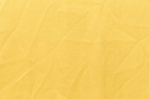服装黄色面料纹理背景，布料纺织品表面的俯视图图片下载