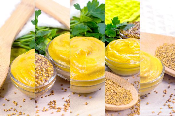 厨房的桌子上摆放着许多黄色的第戎芥末酱，用装满干芥末籽的木勺蘸着玻璃，作为食物拼贴的照片图片下载