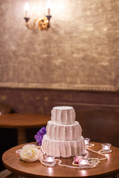 多层婚礼蛋糕放在桌子上，还有蜡烛图片下载