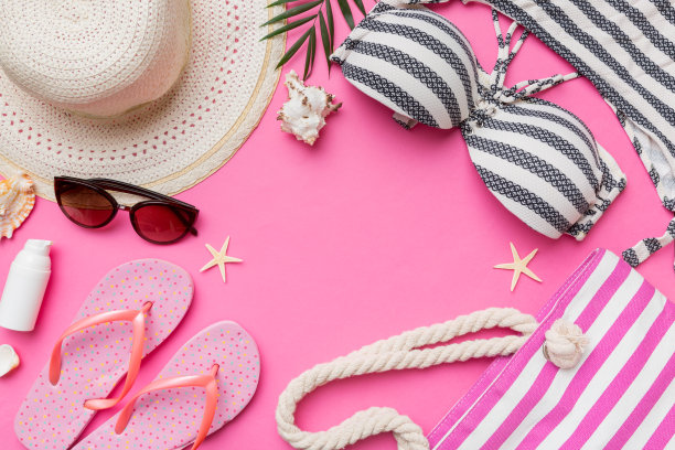 女子泳装和海滩配件平铺顶视彩色背景夏季旅行的概念。比基尼泳装，草帽和高跟鞋。复制空间俯视图图片下载