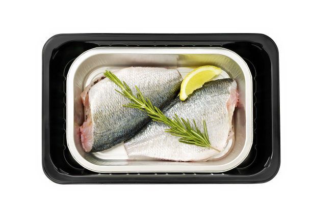 两条新鲜未经烹饪的鲷鱼，配以香草和柠檬片图片下载
