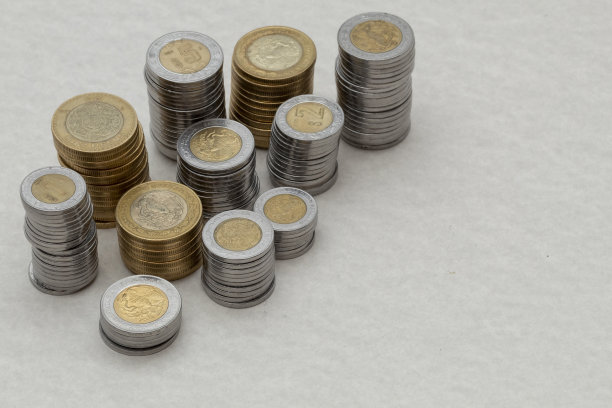 不同面额的墨西哥比索硬币堆放在一张有复印空间的桌子上图片下载