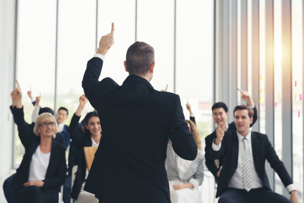 高级商务人士在讲台上发言的背影。商务人士在商务会议室开会图片下载