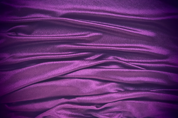 丝绒织物，类似丝绸纺织品的褶皱和美丽的波浪。窗帘上有紫色，粉色，品红色。晚礼服、家具、室内装饰、窗帘、室内装饰的缝纫材料图片下载
