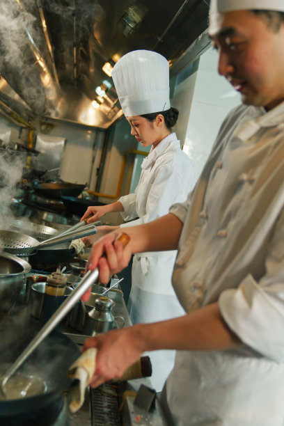 后厨内的专业厨师团队烹饪美味佳肴图片下载