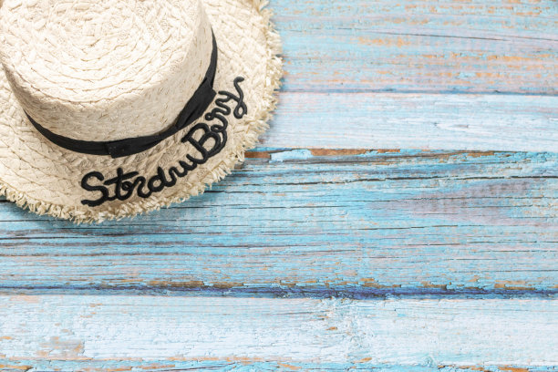 浅蓝色木制背景草帽，沙滩和夏日概念。图片下载