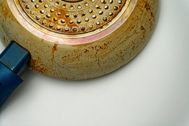 平底锅底部有褐色油脂痕迹，白色孤立背景上有蓝色把手图片下载