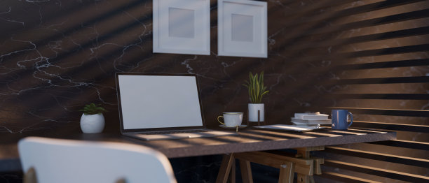 时尚的办公桌工作区与笔记本电脑模型在桌子上对着深色大理石墙图片下载