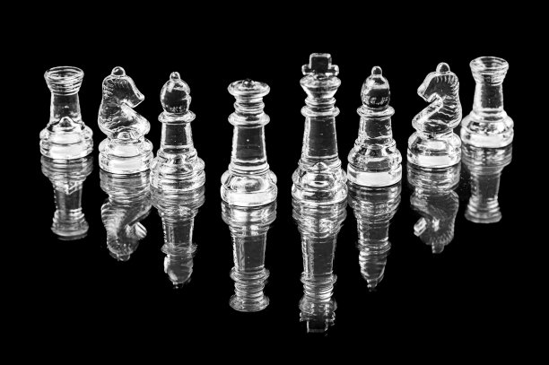 透明玻璃象棋在黑色背景，选择性聚焦国王和皇后的棋子，特写图片下载