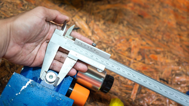 用游标卡尺测量机械零件。图片下载